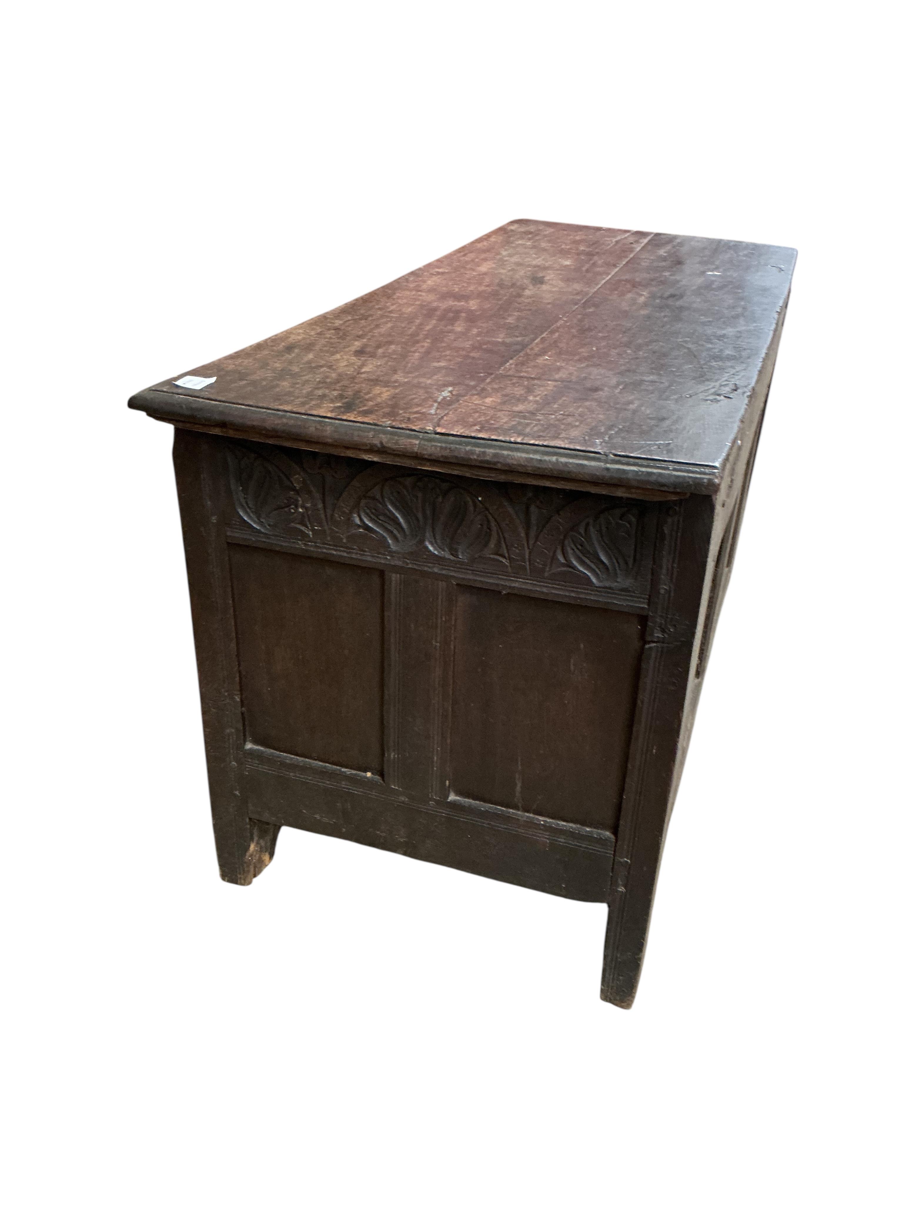 An 18th century carved oak coffer, width 132cm, depth 56cm, height 64cm